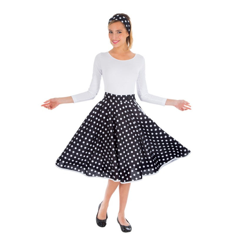 The image shows a black skirt with white polka dots and a matching headband, both designed as a two-piece set, likely intended for party or costume use.