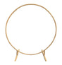 The image shows a large, circular metal arch with a gold finish, likely intended for use as a decorative structure at a party or ceremony.
