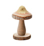 The image shows a decorative gold-glittered mushroom ornament on a wooden base, likely intended as a party decoration.