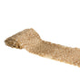The image shows a party table runner made of faux fur with a brown and white suede-like appearance, measuring 20cm x 2m, laid out on a table.