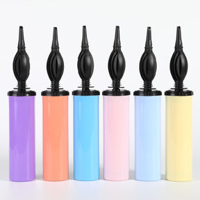 The image shows a balloon pump with a dual-action (push-pull) mechanism, designed for inflating balloons.