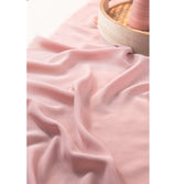 The image shows a decorative roll of pink mesh or tulle fabric, likely intended for party decoration purposes.