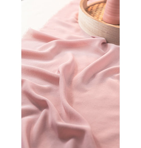 The image shows a decorative roll of pink mesh or tulle fabric, likely intended for party decoration purposes.